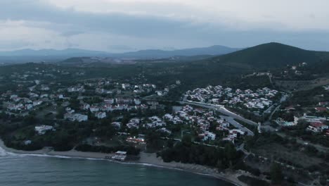 Drone-shot-over-houses-and-the-beach-at-the-evening-in-Greece