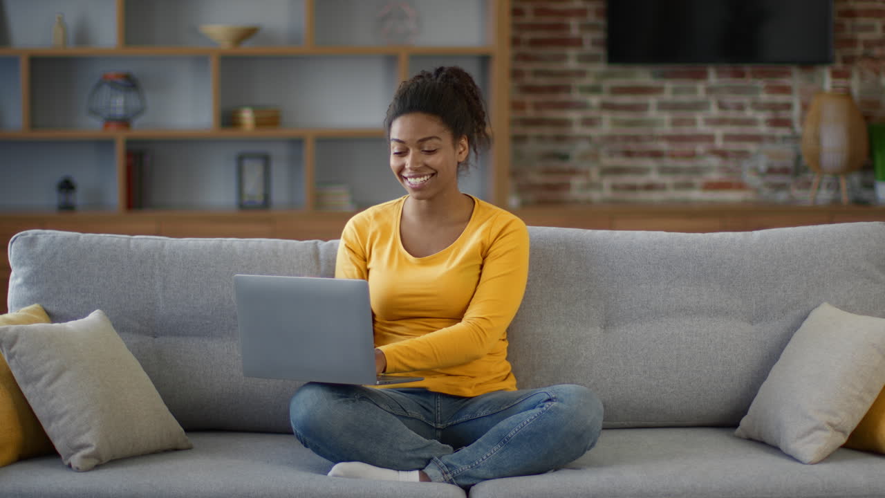 Woman Working on Laptop at Home