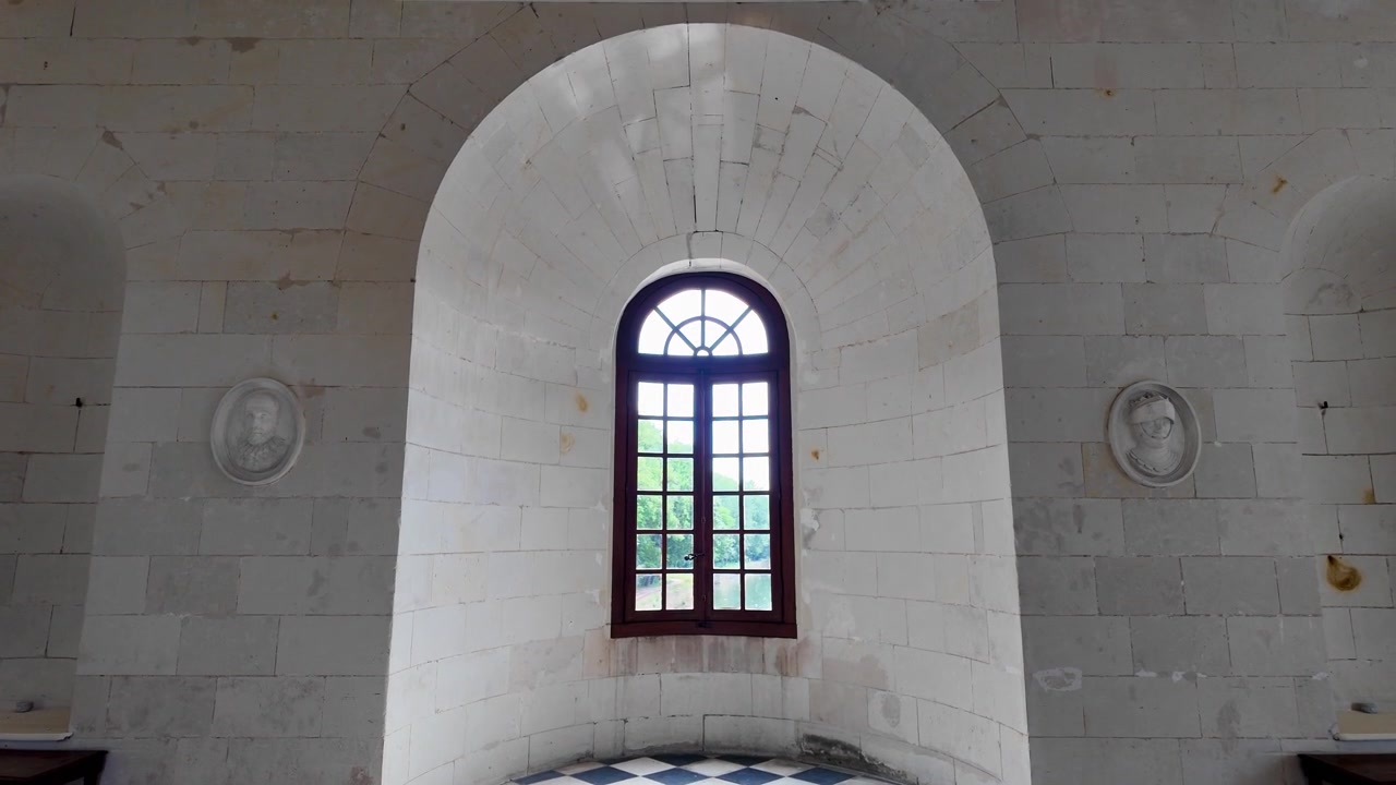 Elegant ground-floor hall of Château de Chenonceau displaying Renaissance architectural details, geometric tiled flooring, white stone arches, and a refined historic atmosphere in the Loire Valley