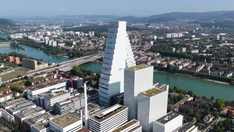 the roche tower roche turm, bau 1 in basel, switzerland. aerial drone video