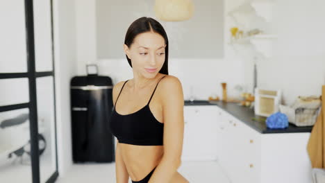 woman in black lingerie in modern kitchen