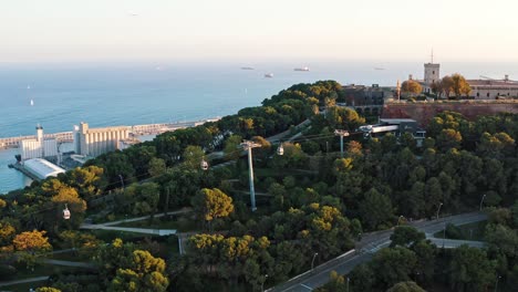 aerial view of cableway on montjuic hill with montjuic castle on it, sea cargo port of barcelona. panoramic seascape. catalonia, spain