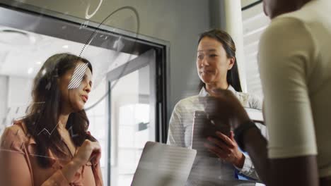animation of data processing and globe over diverse business people talking in office