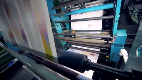 close-up view of a newspaper printing process.