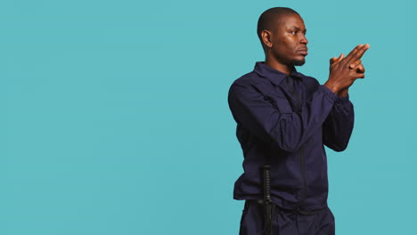 guardian prepared to handle security breaches, doing pistol fingers gesturing