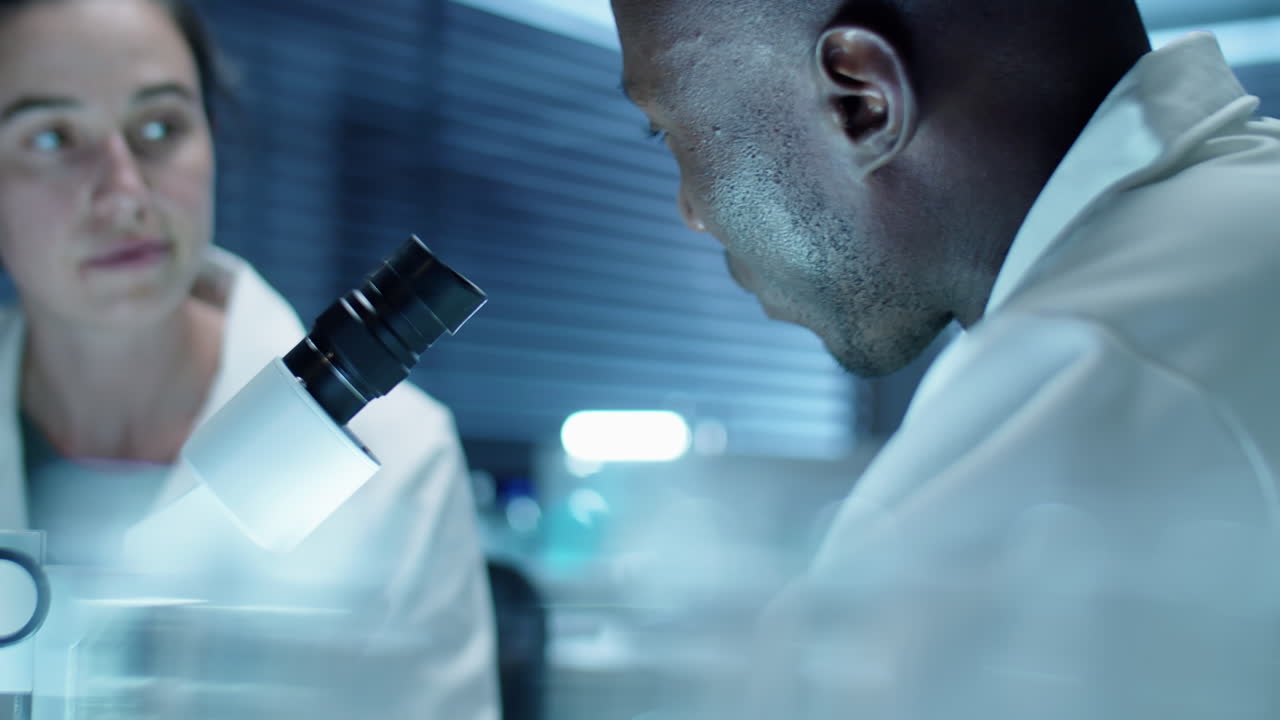 Scientist Doing Lab Research with Female Assistant