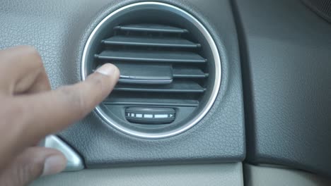adjusting a car's air conditioning vent