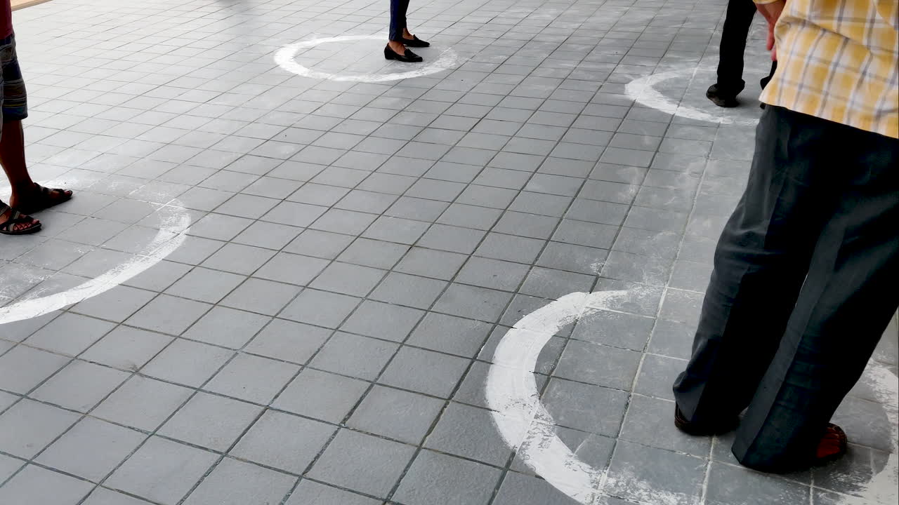 People Practice Social Distancing Outside Grocery Store. Customers Standing Inside Circle At two meters Distance To Prevent The Spread Of COVID-19