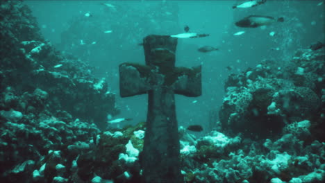 sunken cross in underwater coral reef