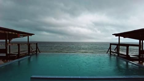 timelapse footage of pouring rain in the swimming pool on the beach side