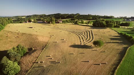 aerial view of tractor harvesting straw bales.