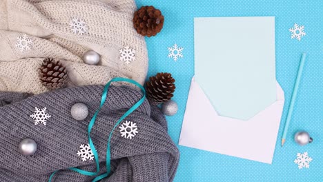 paper in envelope for writing wishes for christmas and winter decoration with ornaments and blinking lights on sweater. stop motion