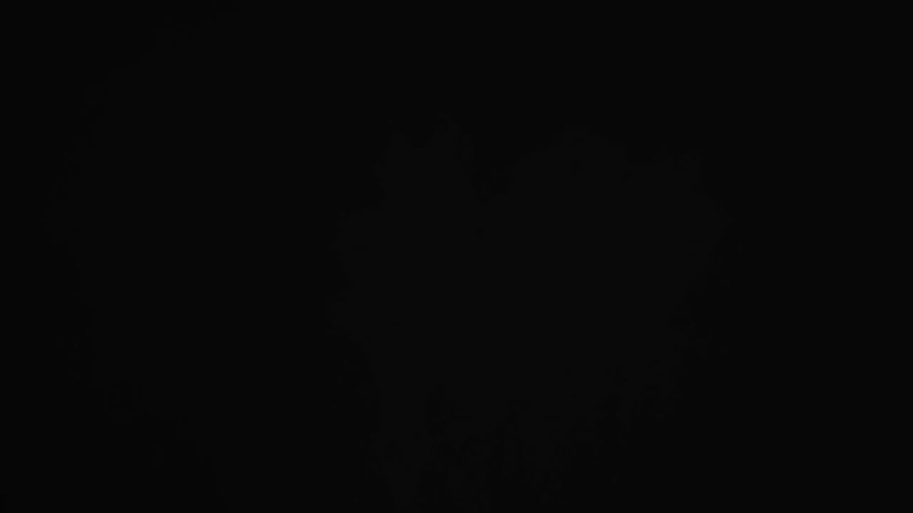 Video of sand grains thrown in air and copy space on black background