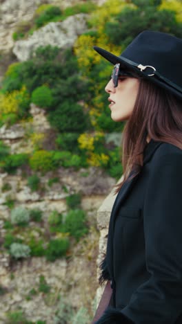 woman admiring the beauty of the environment down the cliff