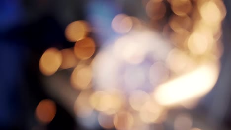 the worker cuts metal pipes with a grinder in defocus