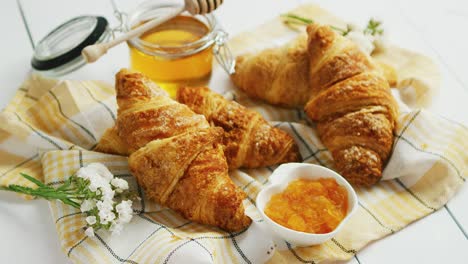 condiments and croissants lying on towel