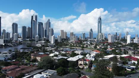 Unique-aerial-view-of-real-estate-property-canal-housing-close-to-the-towering-Gold-Coast-Australia-skyline