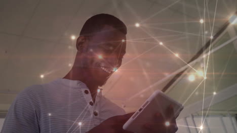 Animation of network of connections with light spots over african american businessman