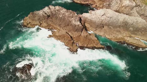 Water-crashing-against-rock-on-the-shoreline