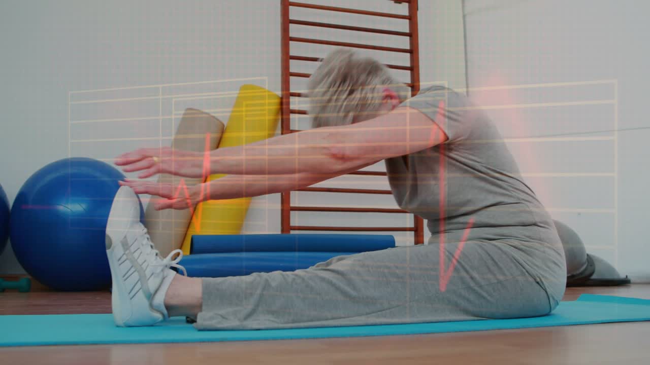 Senior woman inhaling, reaching into seated forward bend on blue mat, red ECG overlay aiding rehab