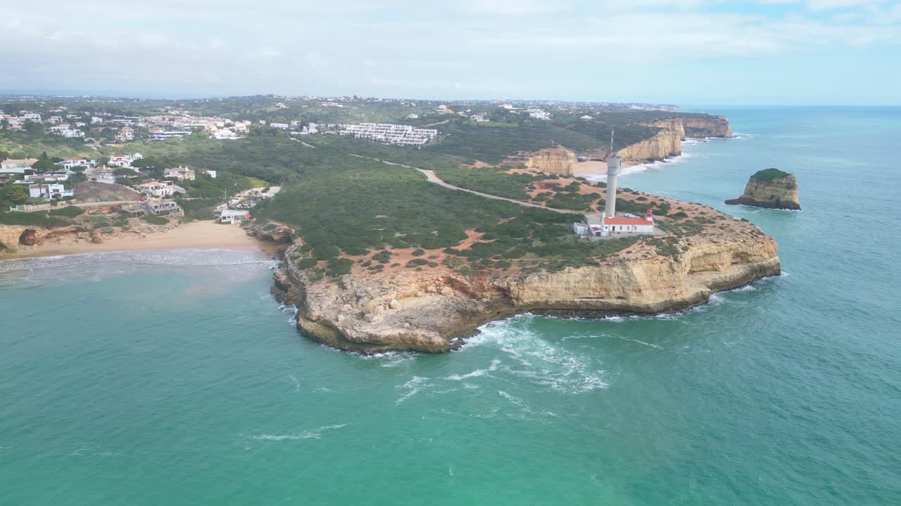 Cliffside lighthouse on Algarve coast with turquoise water and peaceful summer mood