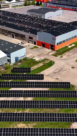 commercial buildings and solar panel field, aerial vertical view