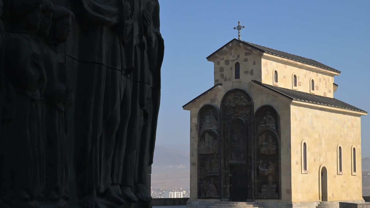 The Church of Annunciation motif within the Chronicle of Georgia combines religious architecture and sculpted reliefs to form a striking spiritual landmark