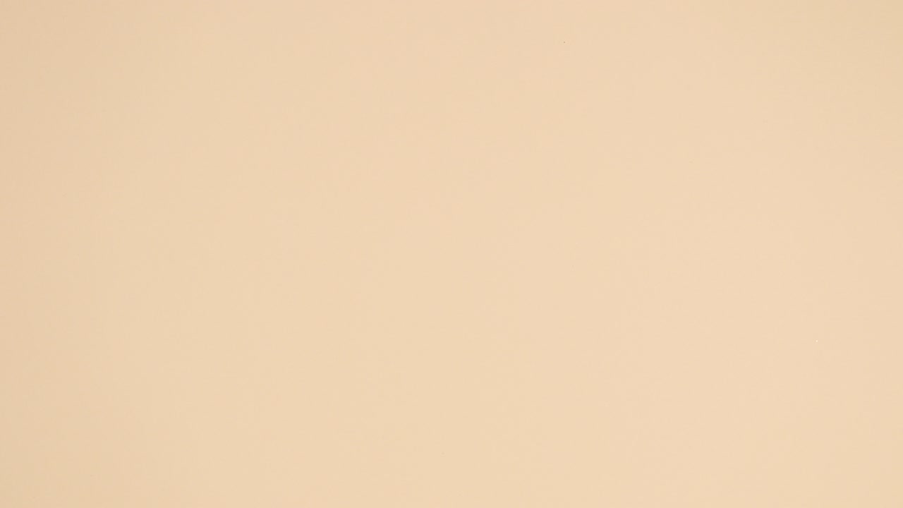 Tropic concept of green  and gold palm leaves appear on nude background. Stop motion