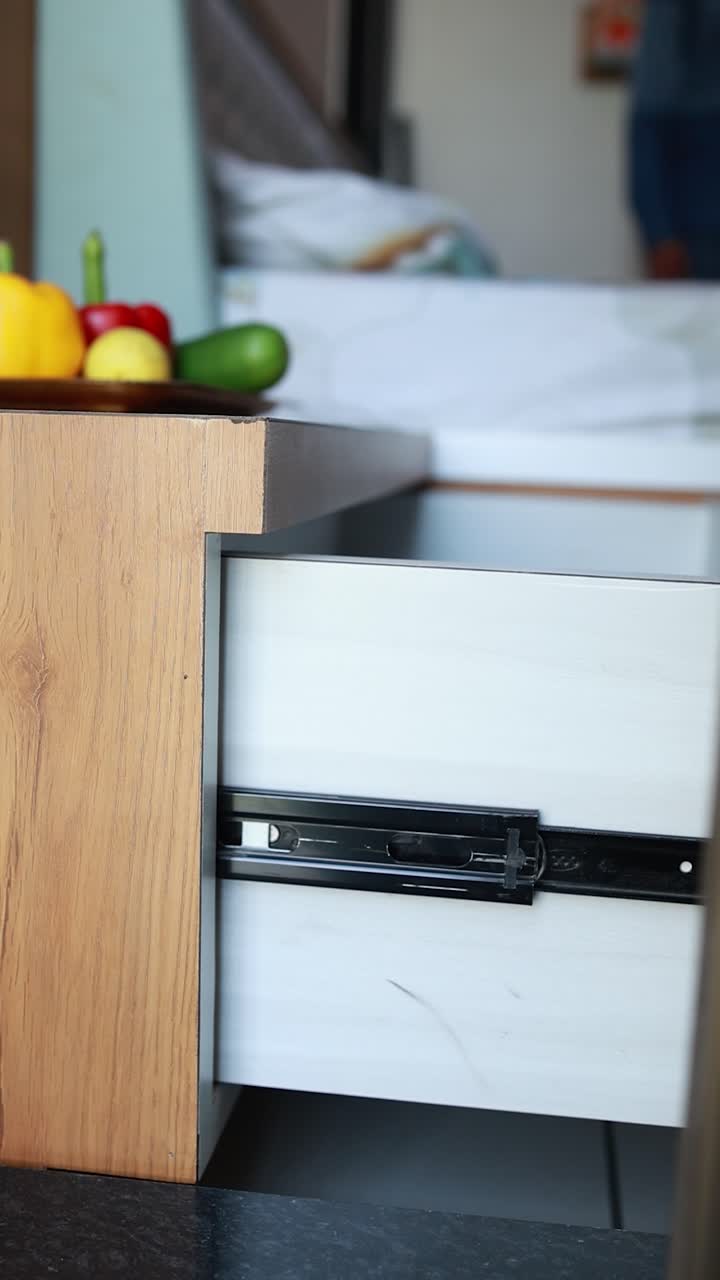 woman pulling a furniture sliding door in the kitchen