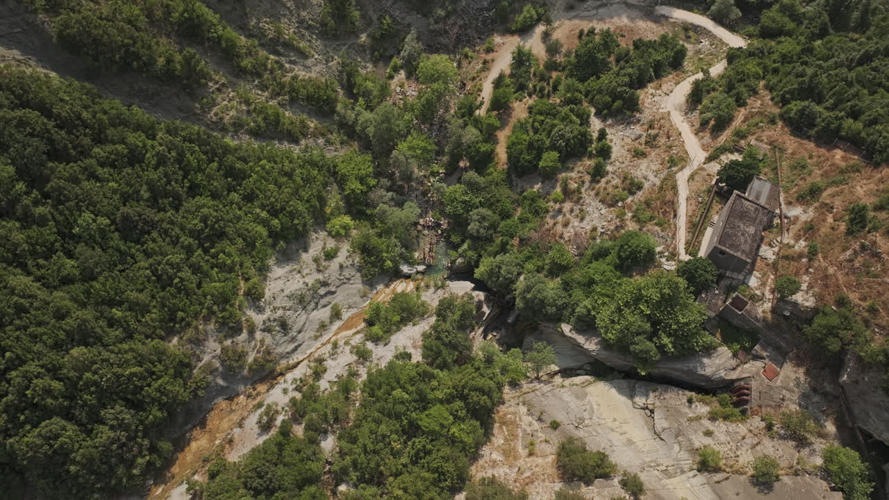 Bogove Waterfall Albania Aerial v4 descending vertical flyover spring water rock pool capturing serene environment surrounded by forested mountain views - Shot with Mavic 3 Pro Cine - July 11th 2024