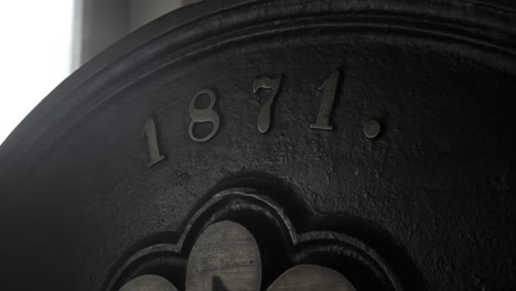 Close-up-shot-of-a-part-of-printing-press-machine,-metal-face-with-a-numbers-on-it