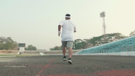Back Of Overweight Man Running For Exercising
