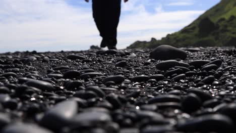 black beach iceland man walking towards camera