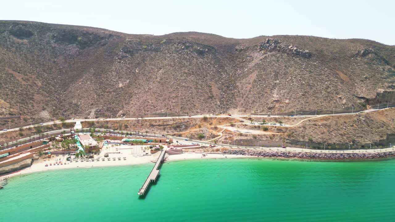Playa coromuel, la paz, showcasing the coastline, clear waters, and surrounding hills, aerial view