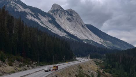 Coquihalla-Highway-Mountain-Journey:-Heavy-Duty-Bulldozer-Haul-with-Zopkios-Peak-in-the-Background