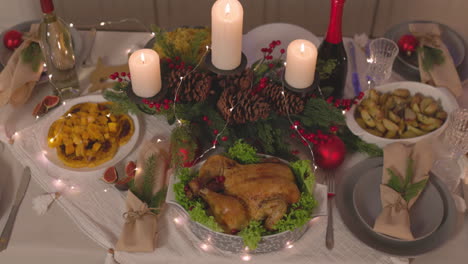 traditional delicious food and burning candles on the table for christmas celebration