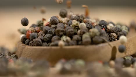 mixed peppercorns in a super slow motion. dry mix peppercorns close up.