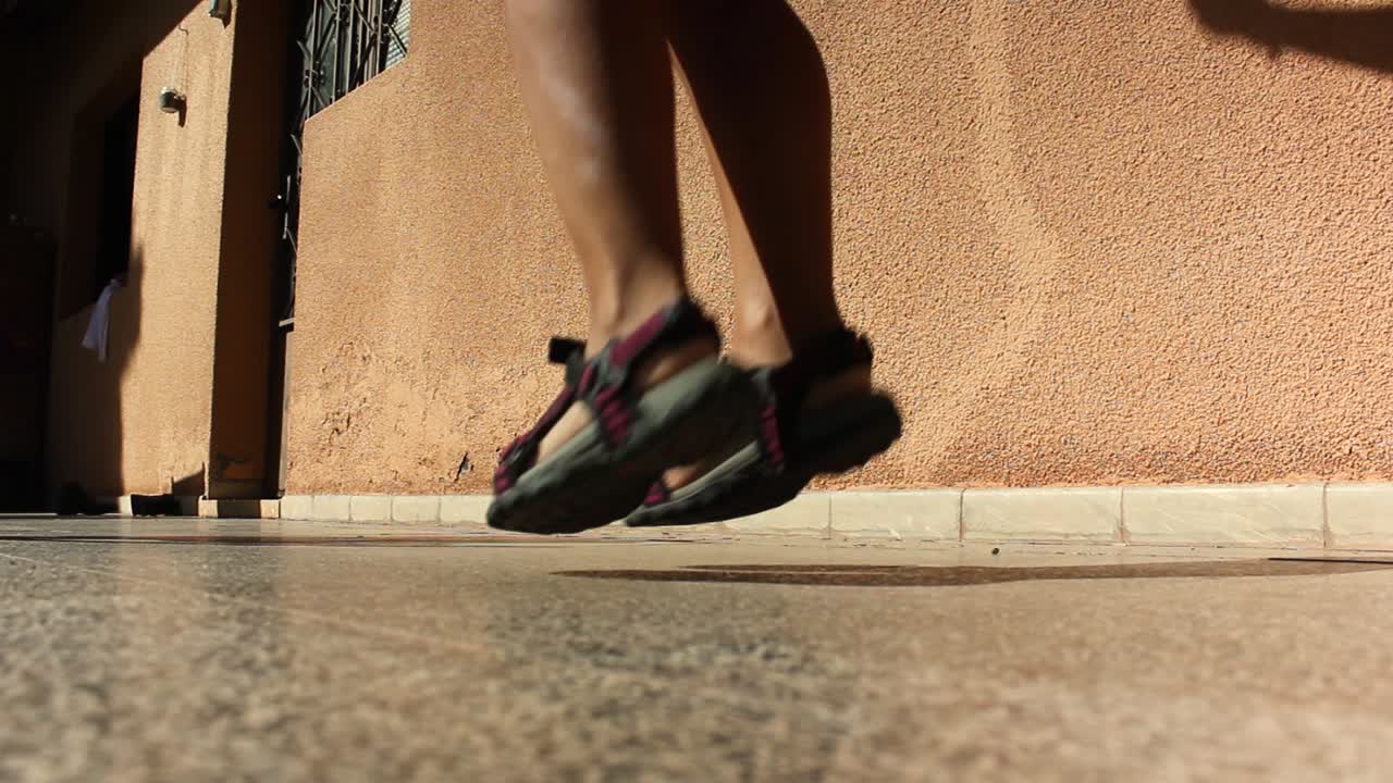Close up of a girl's legs jumping fast with a rope