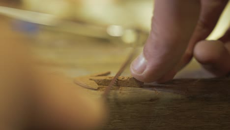 Trimming-mahogany-handcrafted-anchor-for-bracelet