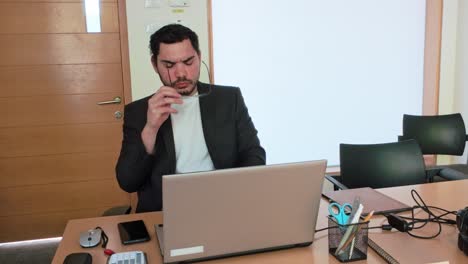 young businessman thinking at laptop