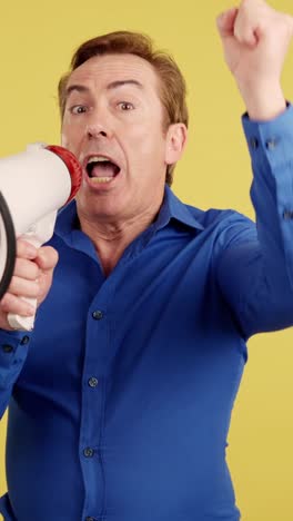 man shouting into megaphone with urgency