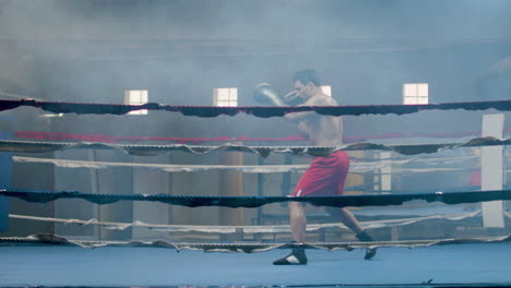 Strong-male-athlete-doing-shadow-fight-in-boxing-gym