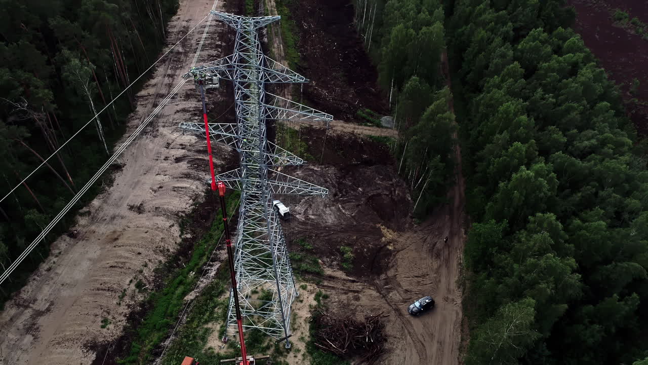 Transmission tower in clearing in forest
