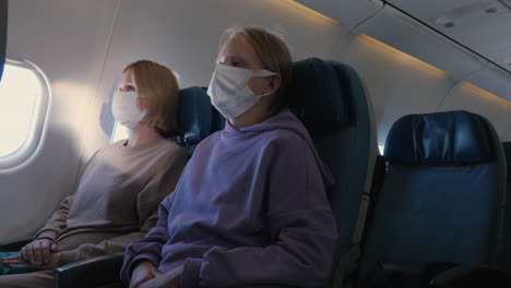 families in protective masks during a long and tiring flight