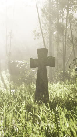 stone cross in a foggy forest