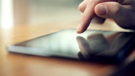 man using tablet computer close-up