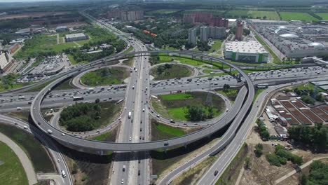 flying over busy interchange with circular transport traffic in moscow, russia