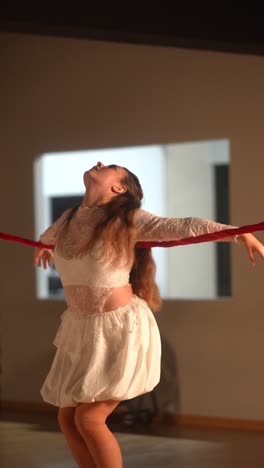 contemporary dance performance with red rope