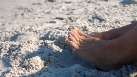 Close-up-view-of-woman-foot-on-sand-