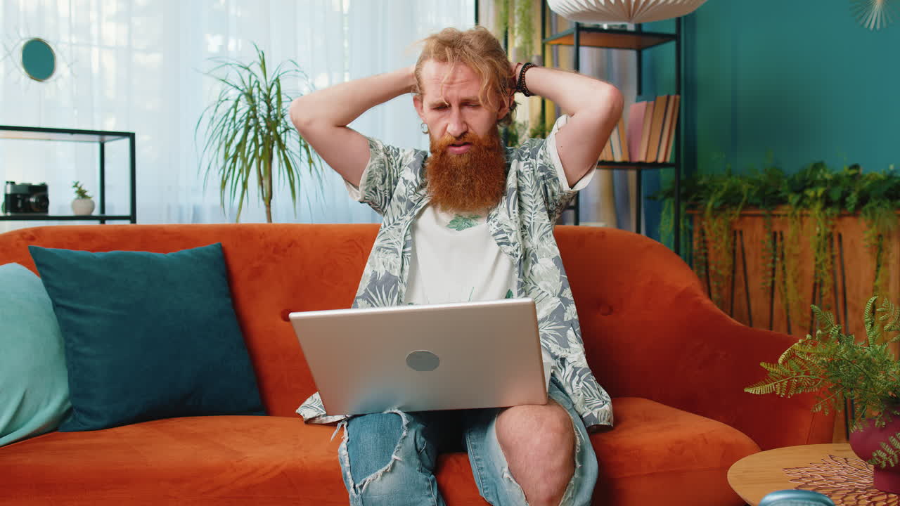 Caucasian young man use laptop surprised by bad news fortune loss fail lottery results at home
